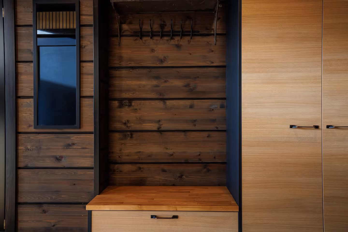 Entrance hall with a timber bench, coat hooks and built-in storage