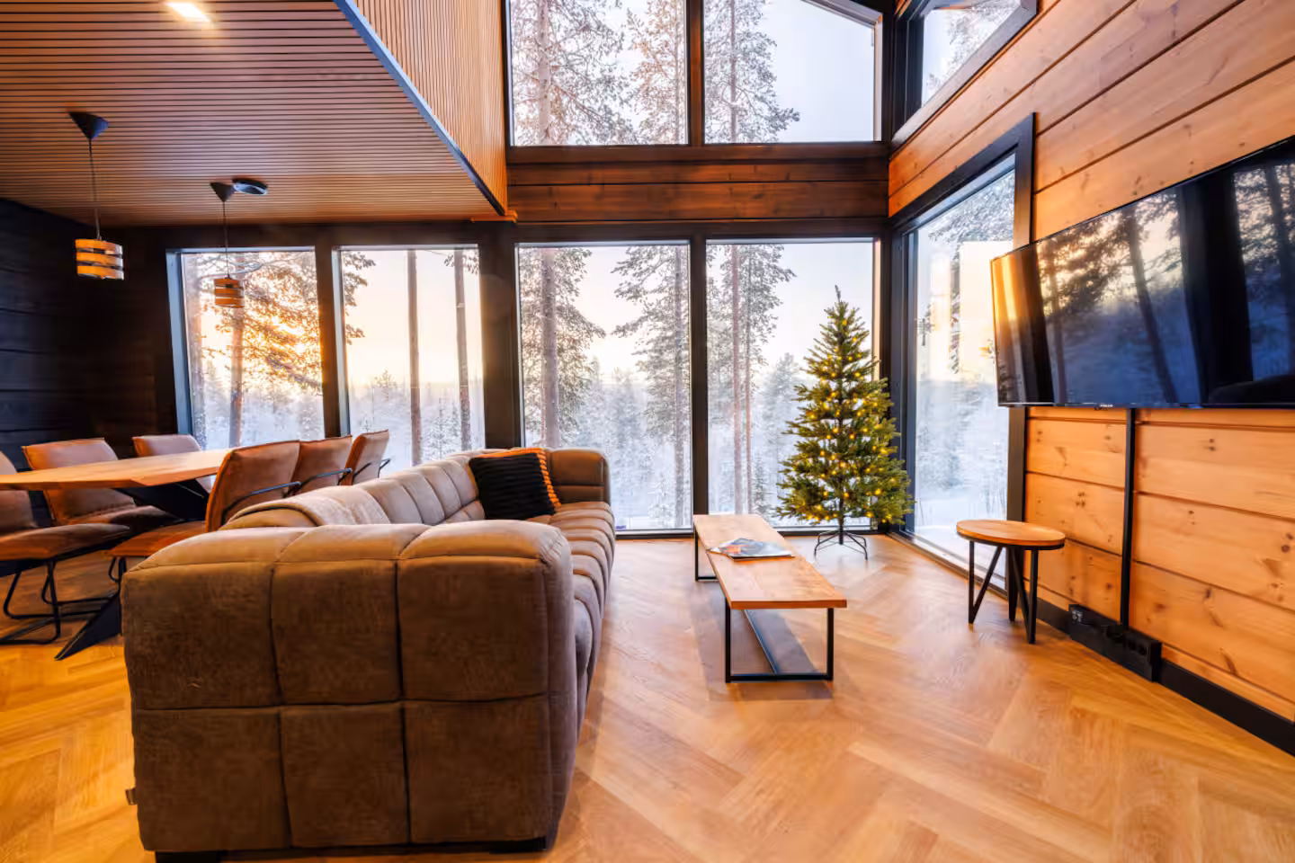 Living room with a decorated spruce tree beside the window wall